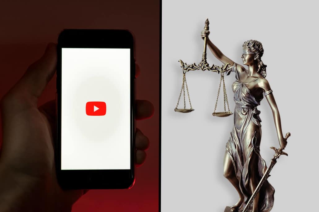 Ein Smartphone mit dem YouTube-Logo und eine Justitia-Figur