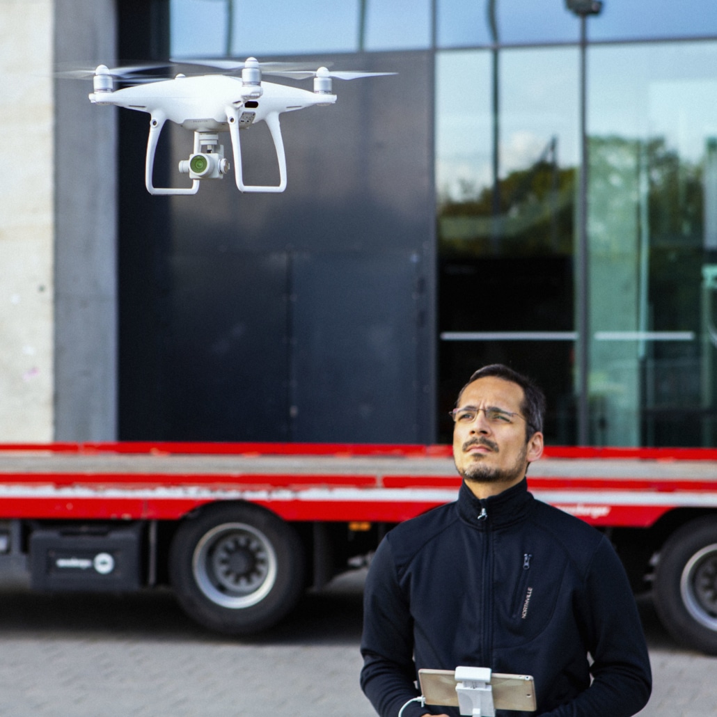 A man using a drone to produce a drone video.